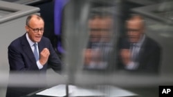 FILE - German opposition leader and Christian Union parties floor leader Friedrich Merz speaks at the the beginning of a debate about migration at the German parliament Bundestag in Berlin, Germany, Jan. 29, 2025. 