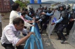 FILE - Pakistani police try to stop journalists during a rally to mark World Press Freedom Day in Islamabad, May 3, 2018.