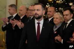 FILE - Wladyslaw Kosiniak-Kamysz deputy Prime Minister and Defence Minister, center, attends the swearing-in ceremony at the presidential palace in Warsaw, Poland, December 13, 2023.