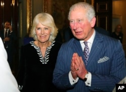 FILE - Britain's Prince Charles and Camilla, Duchess of Cornwall attend the annual Commonwealth day reception at Marlborough House, the home of the Commonwealth Secretariat, in London, March 9, 2020.