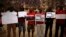 Nigerians take part in a protest, called by Malaga's Nigerian women Association, for the release of the abducted secondary school girls from the remote village of Chibok in Nigeria, at La Merced square in Malaga, southern Spain May 13, 2014. The leader of