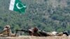 FILE - A Pakistani soldier takes position in Manatu mountain at the central part of Kurram Agency, Pakistan's tribal belt bordering Afghanistan, during an operation against militants, July 10, 2011. 