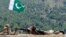 FILE - A Pakistani soldier takes position in Manatu mountain at the central part of Kurram Agency, Pakistan's tribal belt bordering Afghanistan, during an operation against militants, July 10, 2011. 