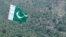 FILE - A Pakistani flag flies at Manatu mountain in the central part of Kurram Agency, Pakistan's tribal belt bordering Afghanistan, July 10, 2011. 