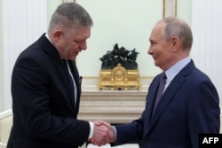 FILE - In this photo distributed by Russian state agency Sputnik, Russia's President Vladimir Putin shakes hands with Slovakia's Prime Minister Robert Fico prior to their talks in Moscow on Dec. 22, 2024.