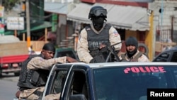 FILE - Haitian national police officers patrol a street of Port-au-Prince, Haiti, Nov. 16, 2016. 