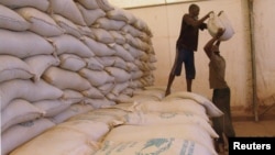 Men transport food aid intended for recently liberated portions of the country, near Sevare, Mali, Feb. 4, 2013.