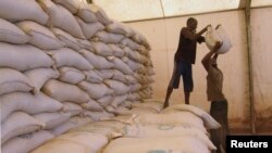 Men transport food aid intended for recently liberated portions of the country, near Sevare, Mali, Feb. 4, 2013.