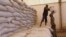Men transport food aid intended for recently liberated portions of the country, near Sevare, Mali, Feb. 4, 2013.