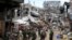 Government soldiers stand in front of damaged houses and buildings in Marawi city, Philippines, Oct. 25, 2017.