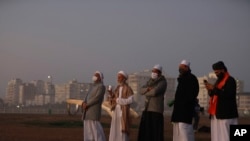 FILE - Muslim clerics scan the skies over Cape Town, South Africa, for a new moon marking the end of Ramadan, May 23, 2020. Some South Africans are chafing at the country’s refusal to recognize religious marriages. 