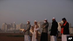 FILE - Muslim clerics scan the skies over Cape Town, South Africa, for a new moon marking the end of Ramadan, May 23, 2020. Some South Africans are chafing at the country’s refusal to recognize religious marriages. 