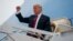 FILE - President Donald Trump gestures as he arrives at Springfield-Branson National Airport before attending a campaign rally in Springfield, Missouri, Sept. 21, 2018.