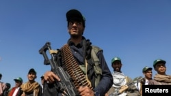 FILE - Houthi-mobilized fighters parade during a ceremony marking the 10th anniversary of the Houthi takeover in Sanaa, Sept. 21, 2024. 