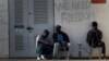 FILE - African migrants sit outside Holot detention center in the Negev Desert, southern Israel, April 21, 2015.