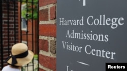 FILE - A sign points the way to the Harvard College Admissions Visitors Center at Harvard University in Cambridge, Massachusetts, U.S., July 6, 2023. (REUTERS/Brian Snyder)