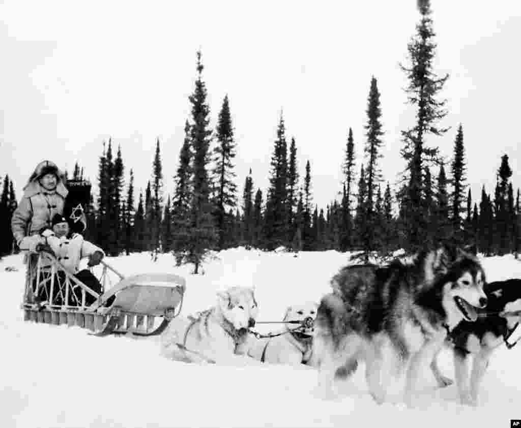 1945: Jewish Chaplain Harold Gordon and Catholic Chaplain William Woods use dog sleds when they can’t get to the men by the planes of the Army Transport Command for Passover and Easter services. (Photo courtesy Jewish Chaplains Council)