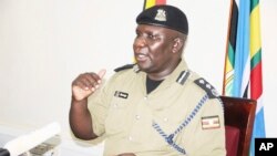 Police Spokesman Fred Enanga addressing a news Conference at the Police headquarters Monday, April 8, 2019. (AP Photo/Ronald Kabuubi)