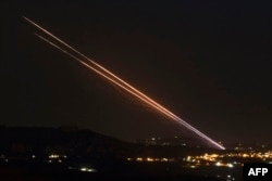 Hezbollah fires a barrage of rockets from a position near the southern Lebanese village of Khiam toward Israel on Oct. 18, 2024.