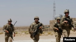 FILE - U.S. troops patrol at an Afghan National Army (ANA) base in Logar province, Afghanistan, Aug. 7, 2018.