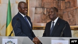 FILE—Gabon's transitional president general Brice Oligui Nguema (L) shakes hands with Ivorian President Alassane Ouattara (R) during a joint press conference at the Presidential Palace, in Abidjan on April 11, 2024.