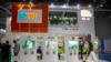 FILE - A visitor wearing a face mask walks past a display from the U.S. Soybean Export Council at the China International Import Expo in Shanghai, Nov. 5, 2020. 