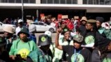 Members of uMkhonto we Sizwe (MK), a new opposition party that has become a potential upsetter in the South Africa May 29 election, sing and dance outside the High Court as Economic Freedom Fighters (EFF) supporters (back) sing and dance in support of for