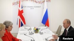 Russia's President Vladimir Putin and Britain's Prime Minister Theresa May attend a meeting on the sidelines of the G20 summit in Osaka, Japan June 28, 2019.