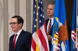 U.S. Secretary of Treasury Steven Mnuchin and FBI Director Christopher Wray, right, arrive at a summit on Combating Anti-Semitism at the Department of Justice in Washington, July 15, 2019.