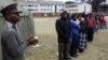 Voters waiting to vote outside a polling station in Harare