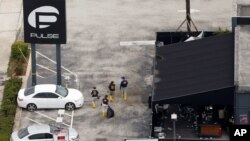 FILE - FBI officials approach the Pulse nightclub, the site of a mass shooting days earlier, in Orlando, Florida, June 15, 2016. Noor Salman, wife of Omar Mateen who shot dead 49 people and wounded more than 50 others at the club, is to face federal charges of obstruction of justice and aiding and abetting her husband's actions.