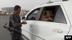 FILE - A Yemeni soldier inspects a vehicle at a checkpoint in the Yemeni capital of Sanaa on July 16, 2014. 