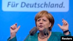 German Chancellor and top candidate of the Christian Democratic Union Angela Merkel makes a speech in the northern German town of Sankt Peter-Ording, July 19, 2013. 