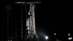 A SpaceX Falcon 9 rocket with the crew capsule Endeavour sits on pad 39A after the launch attempt was scrubbed at the Kennedy Space Center in Cape Canaveral, Florida, Feb. 27, 2023.