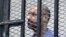 Saif al-Islam Gadhafi, son of Libya's former dictator Moammar Gadhafi, inside courtroom cage, Zintan, Sept. 19, 2013.