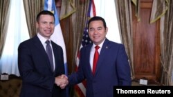 U.S. Department of Homeland Security acting Secretary Kevin McAleenan and Guatemalan President Jimmy Morales shake hands before a bilateral meeting in Guatemala City, Guatemala Aug. 1, 2019.