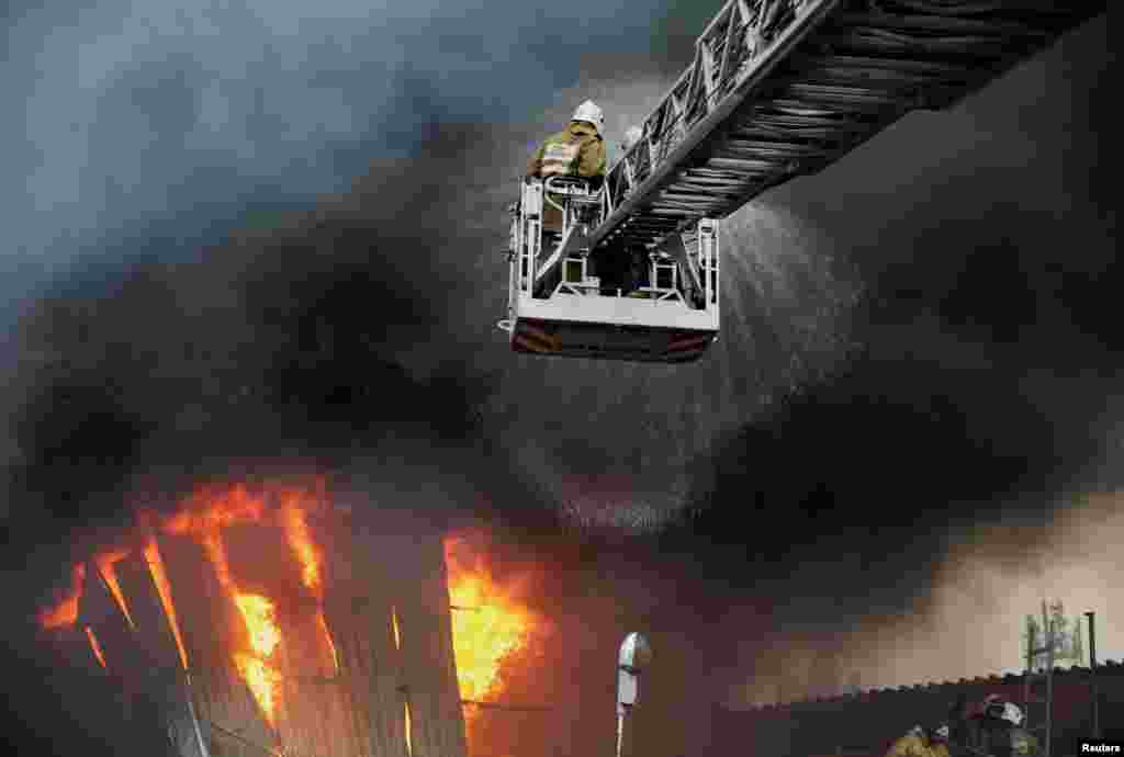 Firefighters work to extinguish a fire at a warehouse in Almaty, Kazakhstan.