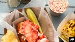 This image released by Goldbelly shows a lobster roll from McLoons Lobster Shack in Maine. (Goldbelly via AP)