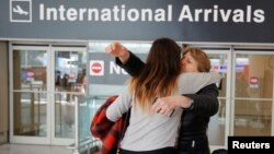 FILE - Mahnaz Kanani Zadeh, right, is greeted by her niece Negin after traveling to the U.S. from Iran following a federal court's temporary stay of U.S. President Donald Trump's executive order travel ban, at Logan Airport in Boston, Massachusetts, Feb. 2017.