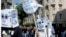 Demonstrators carry a placard which reads in Greek "Fascists Out " during a protest in central Athens, Sept. 23, 2013. 