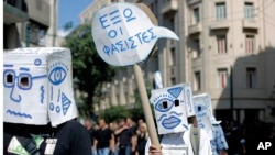 Demonstrators carry a placard which reads in Greek "Fascists Out " during a protest in central Athens, Sept. 23, 2013. Greece's anti-terrorism division has been handed the investigation into the murder of anti-fascist rapper Pavlos Fyssas, blamed on a supporter of the far-right Golden Dawn Party.