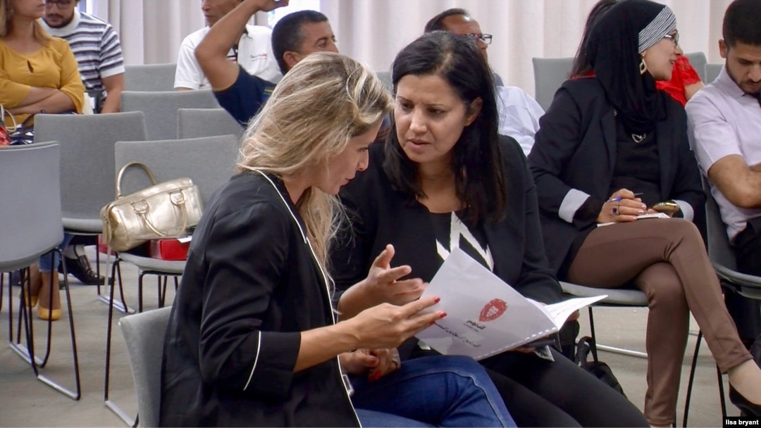 Samira Chaouachi (R) with colleagues at a recent Heart of Tunisia party meeting in Tunis. (L. Bryant/VOA)