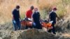 A crew carries what are believed to be remains of a 6-year-old girl, near Xiliatos, Cyprus, June 12, 2019. Cyprus authorities believe the girl was the victim of a confessed serial killer, a Cyprus army captain.