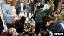 A passenger who was rescued from a train after it was attacked by separatist militants receives medical aid at the Mach Railway Station in Mach, Balochistan, Pakistan, March 11, 2025.