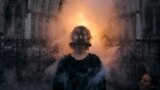 An activist from Ocean Rebellion stands as she wears a scolds bridle medieval torture device, outside the Royal High Court of Justice, in central London, on Jan. 29, 2025. 