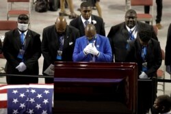 Fraternity members sing in front of the casket of the late Rep. John Lewis, D-Ga., during a service celebrating "The Boy from Troy" at Troy University, July 25, 2020, in Troy, Ala.