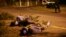 FILE - Bodies of two victims of Mexico's ongoing drug war are seen lying by the side of a road as police secure the area in the city of Veracruz, Mexico.