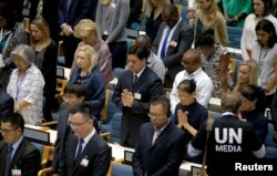 Delegates at the United Nations Environment Programme (UNEP) world environmental forum observe a minute's silence in memory of the victims of Ethiopian Airlines Flight ET 302 plane crash, at the UN complex within Gigiri in Nairobi, Kenya, March 11, 2019.