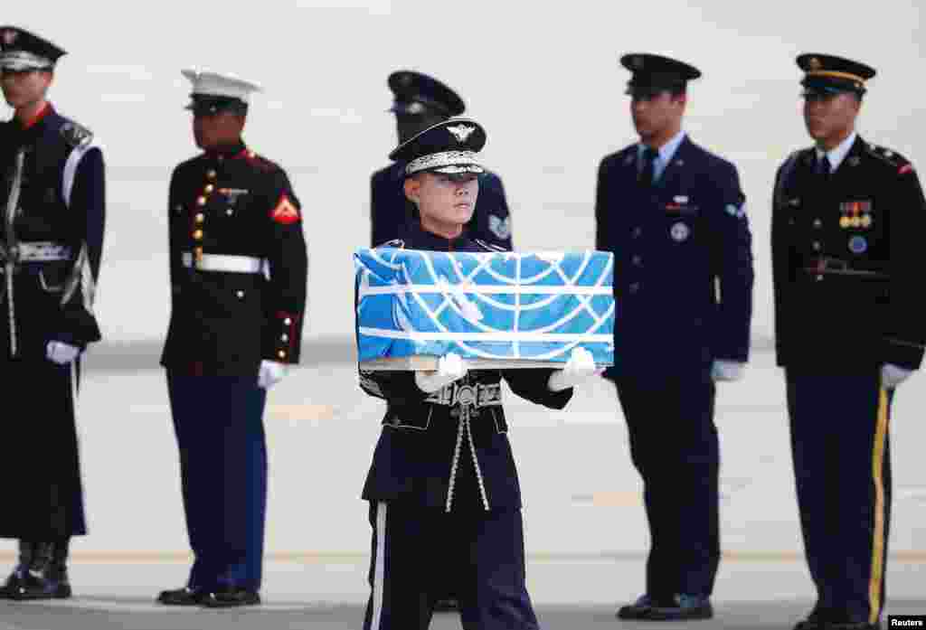 A soldier carries a casket containing the remains of a U.S. soldier who was killed in the Korean War during a ceremony at Osan Air Base in Pyeongtaek, South Korea.