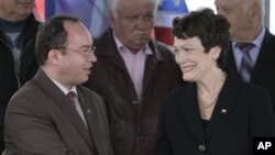 U.S. Undersecretary of State Ellen Tauscher, right, shakes hands with Romanian Foreign Ministry State Secretary Bogdan Aurescu, left, during a ceremony at the Deveselu Air Base, southern Romania, Tuesday, May 3, 2011. Romanian President Traian Basescu ann